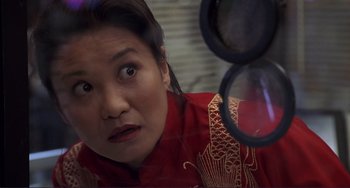 Movie still from “Mighty Joe Young” (1998), directed by Ron Underwood – A person wearing a red shirt; Close Up shot, High angle