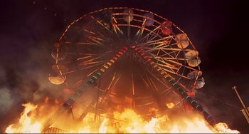 Movie still from “Mighty Joe Young” (1998), directed by Ron Underwood – A ferris wheel that is on fire at night; Extreme Wide shot, Overhead angle