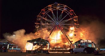 Movie still from “Mighty Joe Young” (1998), directed by Ron Underwood – A ferris wheel that is on fire at night; Extreme Wide shot, Low angle