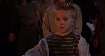 Movie still from “Mighty Joe Young” (1998), directed by Ron Underwood – A young boy is looking into the distance; Close Up shot, High angle
