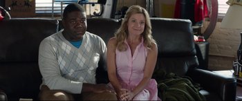 Movie still from “Mike and Dave Need Wedding Dates” (2016), directed by Jake Szymanski – A woman and a man sitting next to each other on a couch; Medium shot, Over the shoulder angle