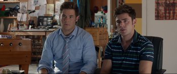 Movie still from “Mike and Dave Need Wedding Dates” (2016), directed by Jake Szymanski – Two young men sitting at a table in a room; Close Up shot, Over the shoulder angle