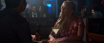 Movie still from “Mike and Dave Need Wedding Dates” (2016), directed by Jake Szymanski – A woman sitting at a table with a drink in front of a man; Medium shot, Over the shoulder angle
