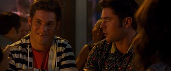 Movie still from “Mike and Dave Need Wedding Dates” (2016), directed by Jake Szymanski – Two young men sitting at a table in a room; Close Up shot, Over the shoulder angle