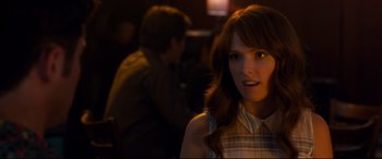 Movie still from “Mike and Dave Need Wedding Dates” (2016), directed by Jake Szymanski – A woman with long red hair is standing in a dark room; Close Up shot, Over the shoulder angle