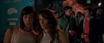 Movie still from “Mike and Dave Need Wedding Dates” (2016), directed by Jake Szymanski – A woman standing next to another woman in a room; Close Up shot, Over the shoulder angle
