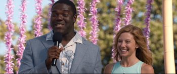 Movie still from “Mike and Dave Need Wedding Dates” (2016), directed by Jake Szymanski – A man holding a microphone next to a smiling woman; Medium shot, Over the shoulder angle