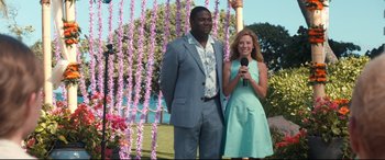 Movie still from “Mike and Dave Need Wedding Dates” (2016), directed by Jake Szymanski – A man and a woman standing next to each other holding microphones; Medium shot, Over the shoulder angle