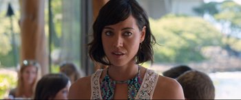 Movie still from “Mike and Dave Need Wedding Dates” (2016), directed by Jake Szymanski – A person with short hair wearing a necklace; Close Up shot, Over the shoulder angle