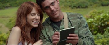 Movie still from “Mike and Dave Need Wedding Dates” (2016), directed by Jake Szymanski – A man and a woman are looking at a tablet; Close Up shot, Overhead angle