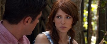 Movie still from “Mike and Dave Need Wedding Dates” (2016), directed by Jake Szymanski – A woman with long brown hair and a blue and white striped shirt; Close Up shot, Over the shoulder angle
