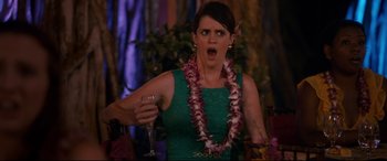 Movie still from “Mike and Dave Need Wedding Dates” (2016), directed by Jake Szymanski – A woman wearing a green dress holding a glass of wine; Medium shot, Over the shoulder angle