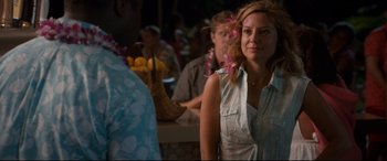 Movie still from “Mike and Dave Need Wedding Dates” (2016), directed by Jake Szymanski – A woman standing in front of a man with flowers in her hair; Medium shot, Over the shoulder angle