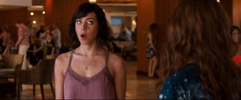Movie still from “Mike and Dave Need Wedding Dates” (2016), directed by Jake Szymanski – A young woman with a surprised look on her face standing next to another woman; Close Up shot, Over the shoulder angle