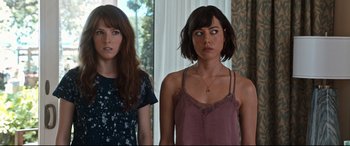 Movie still from “Mike and Dave Need Wedding Dates” (2016), directed by Jake Szymanski – Two women standing next to each other in front of a window; Close Up shot, Over the shoulder angle