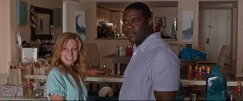 Movie still from “Mike and Dave Need Wedding Dates” (2016), directed by Jake Szymanski – A man and a woman posing for a picture in a living room; Medium shot, Low angle