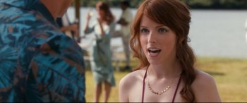 Movie still from “Mike and Dave Need Wedding Dates” (2016), directed by Jake Szymanski – A beautiful young woman with red hair standing in a field; Close Up shot, Over the shoulder angle
