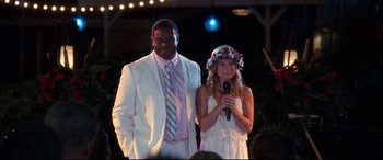 Movie still from “Mike and Dave Need Wedding Dates” (2016), directed by Jake Szymanski – A man and a woman standing next to each other holding microphones; Medium shot, Over the shoulder angle