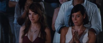 Movie still from “Mike and Dave Need Wedding Dates” (2016), directed by Jake Szymanski – Two beautiful women sitting next to each other in front of a crowd; Close Up shot, Over the shoulder angle