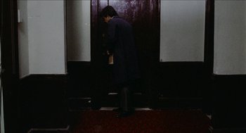 Movie still from “Mikey and Nicky” (1976), directed by Elaine May – A person standing in front of an open door; Wide shot, High angle