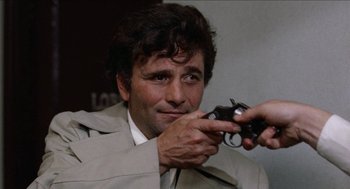 Movie still from “Mikey and Nicky” (1976), directed by Elaine May – A man in a trench coat holding a camera; Close Up shot, Low angle