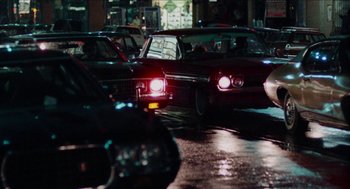 Movie still from “Mikey and Nicky” (1976), directed by Elaine May – A group of cars driving down a street at night; Wide shot, High angle