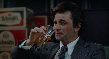 Movie still from “Mikey and Nicky” (1976), directed by Elaine May – A person holding a glass of beer; Close Up shot, Over the shoulder angle