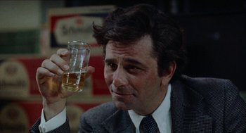 Movie still from “Mikey and Nicky” (1976), directed by Elaine May – A man in a suit and tie holding a glass of beer; Close Up shot, Over the shoulder angle