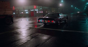 Movie still from “Mikey and Nicky” (1976), directed by Elaine May – A car parked in the middle of the street at night; Wide shot, High angle