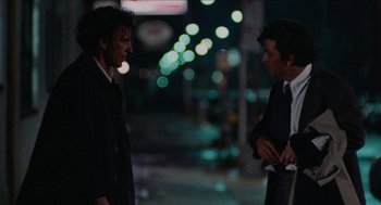 Movie still from “Mikey and Nicky” (1976), directed by Elaine May – Two men in business suits talking on the street; Medium shot, Low angle