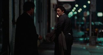 Movie still from “Mikey and Nicky” (1976), directed by Elaine May – A man in a business suit talking to another man in a business suit; Medium shot, Over the shoulder angle