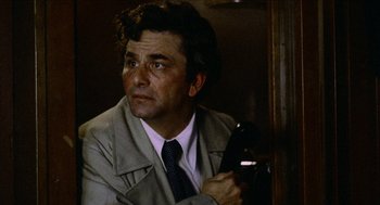 Movie still from “Mikey and Nicky” (1976), directed by Elaine May – A man holding a cell phone while wearing a suit and tie; Close Up shot, Low angle