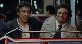 Movie still from “Mikey and Nicky” (1976), directed by Elaine May – A couple of men sitting next to each other on top of a bus; Medium shot, Over the shoulder angle