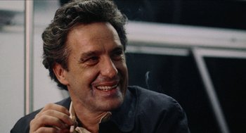 Movie still from “Mikey and Nicky” (1976), directed by Elaine May – A person with a beard smiling; Close Up shot, Low angle