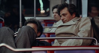 Movie still from “Mikey and Nicky” (1976), directed by Elaine May – Two men sitting on a train and one of the men is sleeping; Medium shot, High angle