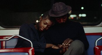Movie still from “Mikey and Nicky” (1976), directed by Elaine May – A man and a woman looking at a cell phone; Medium shot, High angle