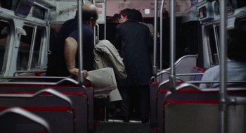 Movie still from “Mikey and Nicky” (1976), directed by Elaine May – A group of people standing on top of a bus; Wide shot, High angle