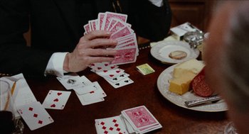 Movie still from “Mikey and Nicky” (1976), directed by Elaine May – A person is holding a deck of playing cards on a table; Extreme Close Up shot, High angle