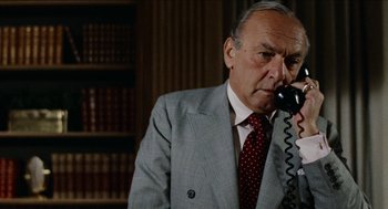 Movie still from “Mikey and Nicky” (1976), directed by Elaine May – An older man wearing a suit and tie talking on a phone; Close Up shot, Low angle