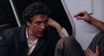 Movie still from “Mikey and Nicky” (1976), directed by Elaine May – A man sitting on a train with his hand on his head; Close Up shot, Over the shoulder angle