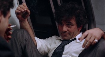 Movie still from “Mikey and Nicky” (1976), directed by Elaine May – A man sitting on top of a train holding a cigarette; Close Up shot, Low angle