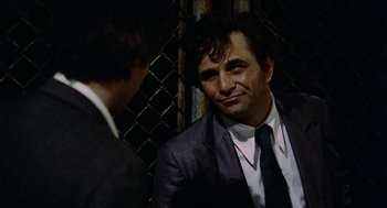 Movie still from “Mikey and Nicky” (1976), directed by Elaine May – A man in a suit and tie talking to another man in a suit and tie; Close Up shot, Over the shoulder angle