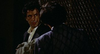 Movie still from “Mikey and Nicky” (1976), directed by Elaine May – A man in a suit and tie talking to another man in a suit and tie; Close Up shot, Over the shoulder angle