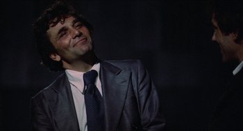 Movie still from “Mikey and Nicky” (1976), directed by Elaine May – A man wearing a suit and tie smiling; Close Up shot, Low angle