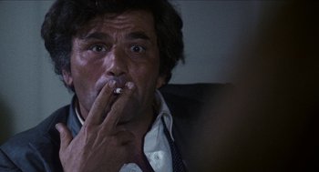 Movie still from “Mikey and Nicky” (1976), directed by Elaine May – A person smoking a cigarette; Close Up shot, Low angle