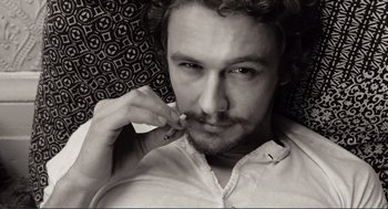 Movie still from “Milk” (2008), directed by Gus Van Sant – Black and white photograph of a man smoking a cigarette; Extreme Close Up shot, Overhead angle