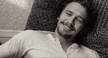 Movie still from “Milk” (2008), directed by Gus Van Sant – A black and white photo of a man smiling; Close Up shot, Overhead angle