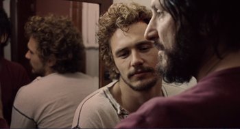 Movie still from “Milk” (2008), directed by Gus Van Sant – A man looking at himself in the mirror; Close Up shot, Over the shoulder angle