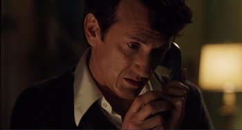 Movie still from “Milk” (2008), directed by Gus Van Sant – A person talking on a cell phone; Close Up shot, Low angle