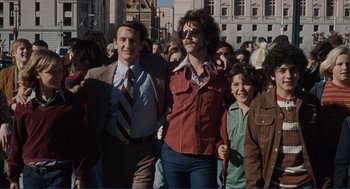 Movie still from “Milk” (2008), directed by Gus Van Sant – A group of people walking down a street; Medium shot, Low angle
